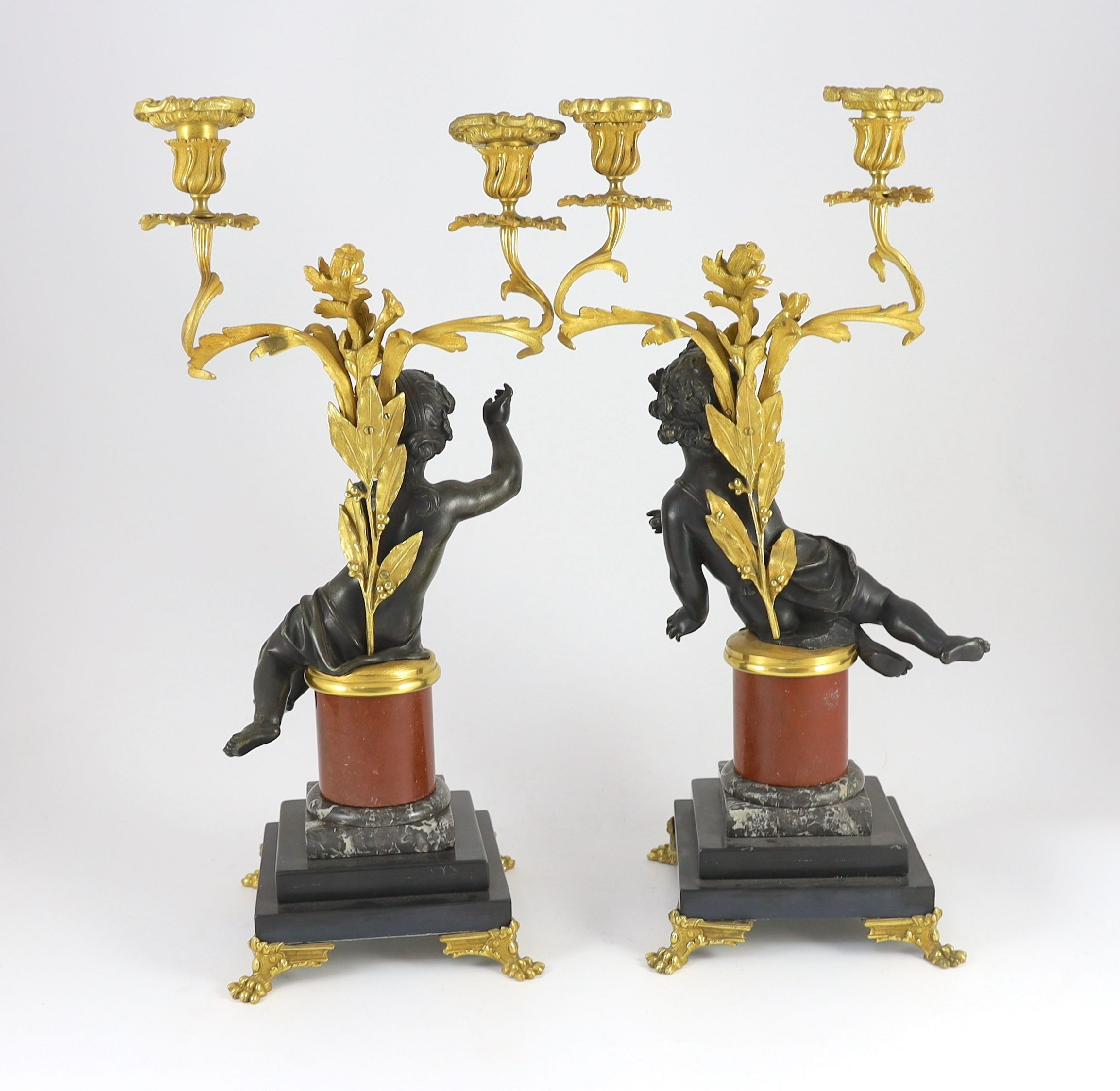 A pair of Louis XVI style bronze and ormolu two light candelabra, 22cm wide, 51cm high